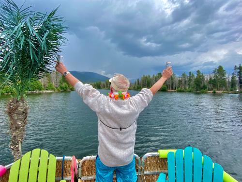 Man on patio looking over Grand Lake