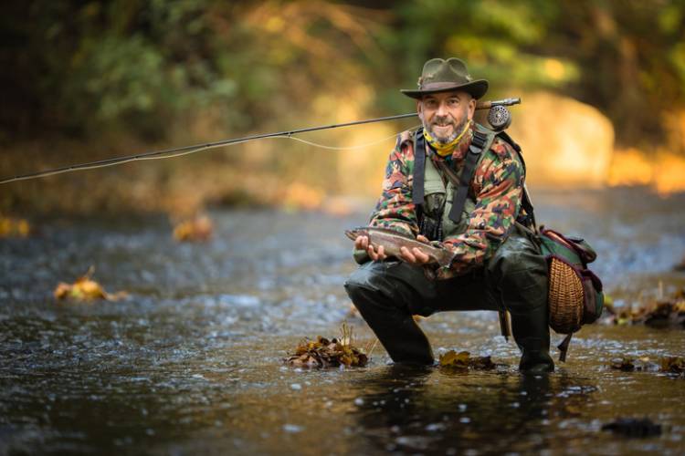 Fisherman with a fish in Grand Lake, CO